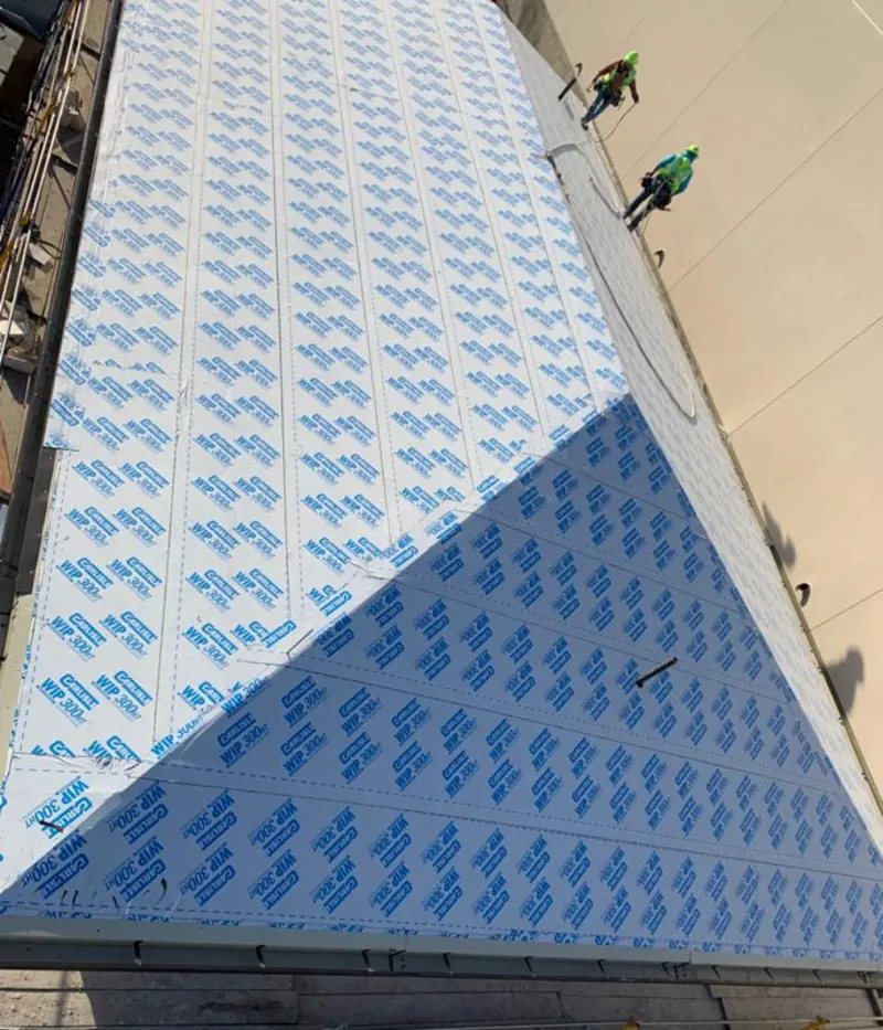 Professional roofers installing underlayment on a metal roof in Markham